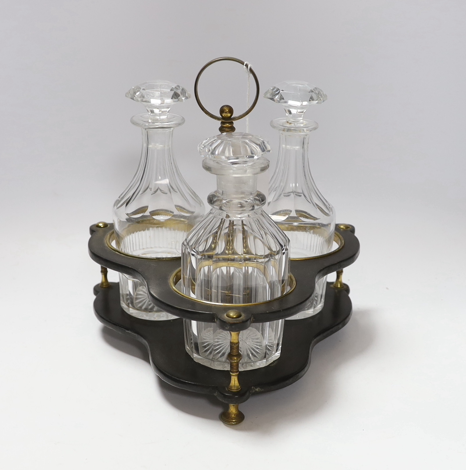 A Regency decanter stand holding three associated cut glass decanters, 24cm